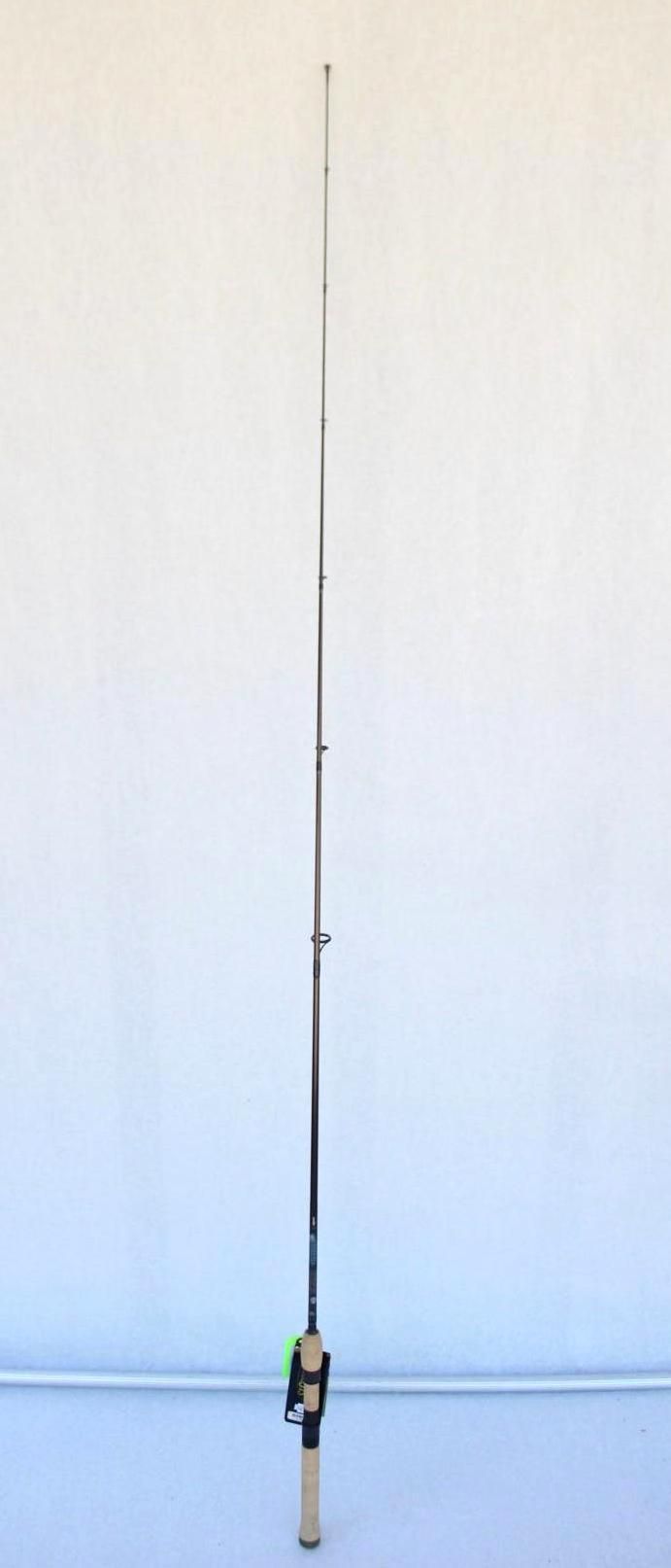 Fishing rod standing upright against a plain white wall.