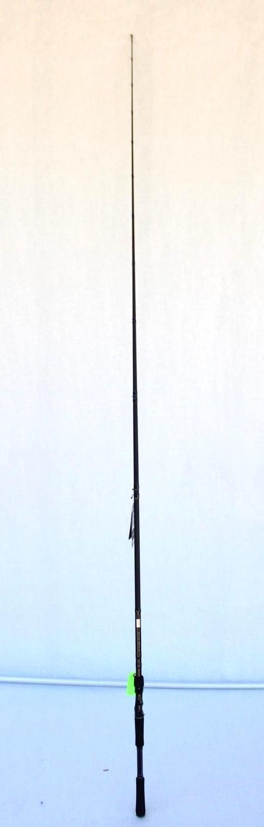 A fishing rod standing upright against a plain white wall.