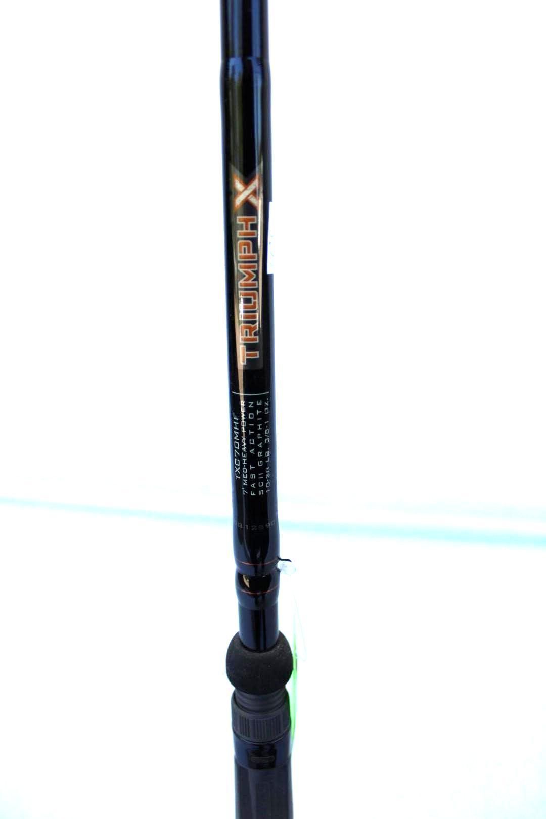 Black fishing rod with gold lettering and a foam handle against a white background