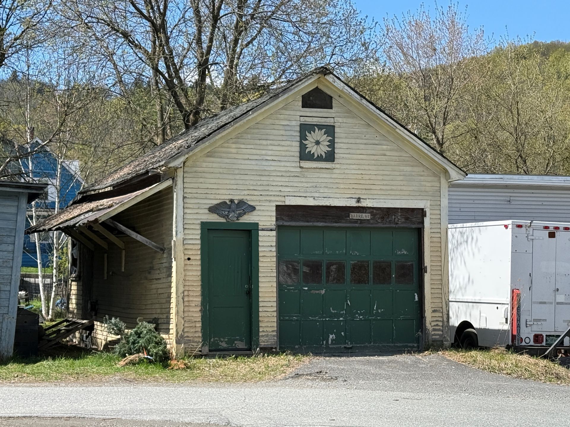 beige garage with green doors and trim