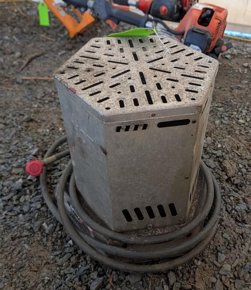 metal utility box with perforated top, sitting on gravel with coiled cables around it.