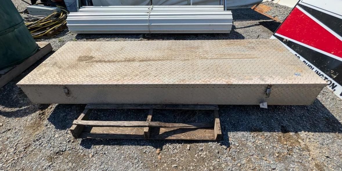 metal storage container on a dolly in a gravel yard