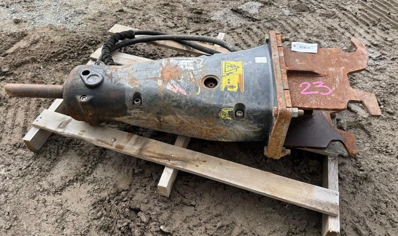 industrial metal attachment lying on wooden pallets