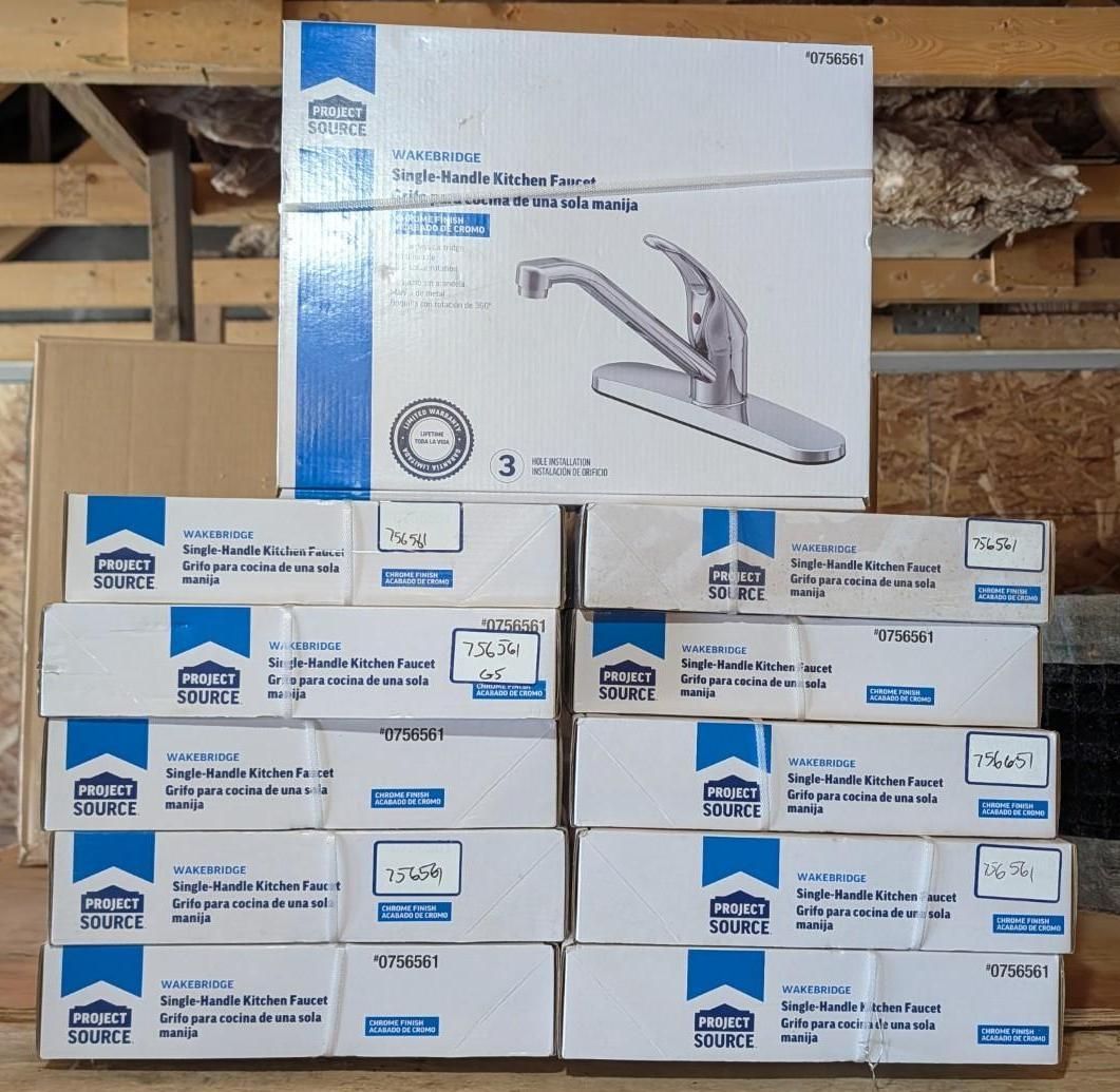 Stacked white product boxes in a warehouse, including a large faucet fixture box on top.
