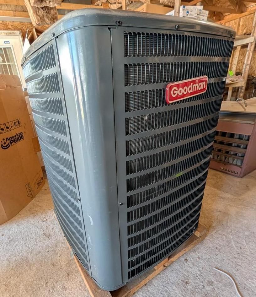 Goodman outdoor HVAC condenser unit in a garage or attic space