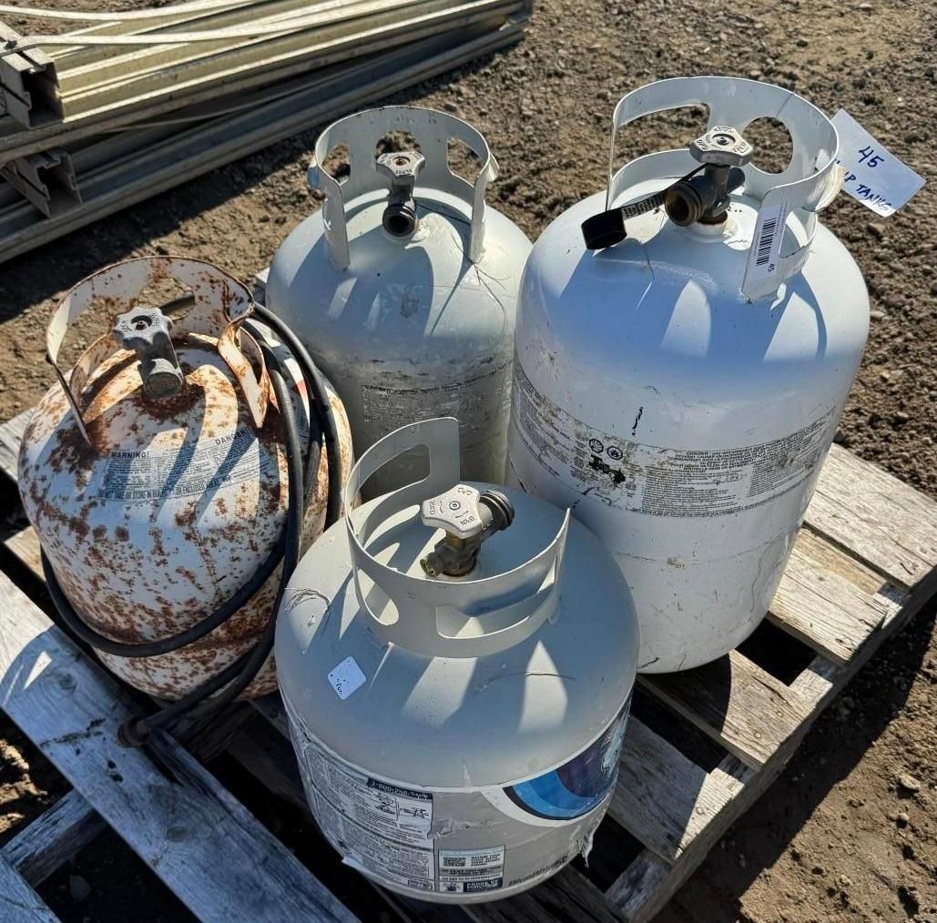 Four propane tanks on a pallet outdoors