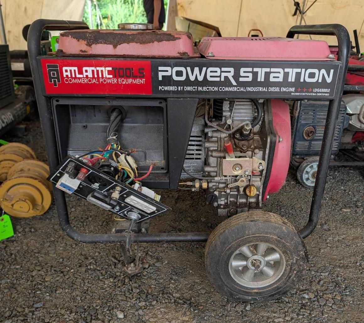 red-and-black power station generator on a trailer in a workshop or yard