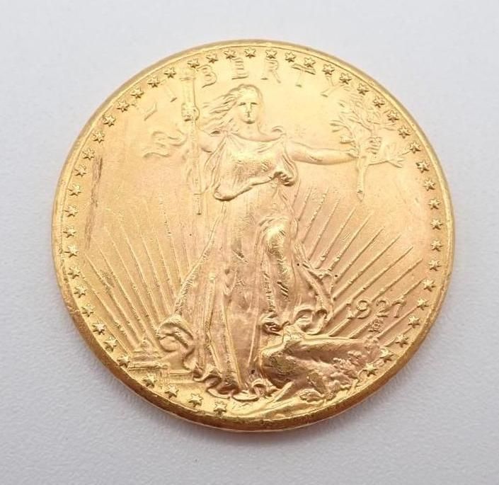 Gold coin with a standing figure holding a staff, surrounded by radiating lines and stars