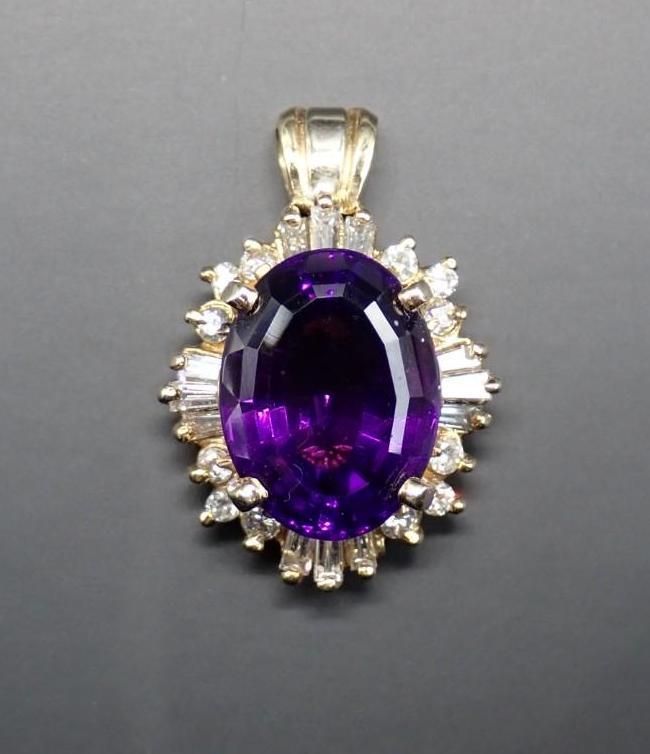 Oval purple gemstone pendant with a clear halo setting on a silver bail