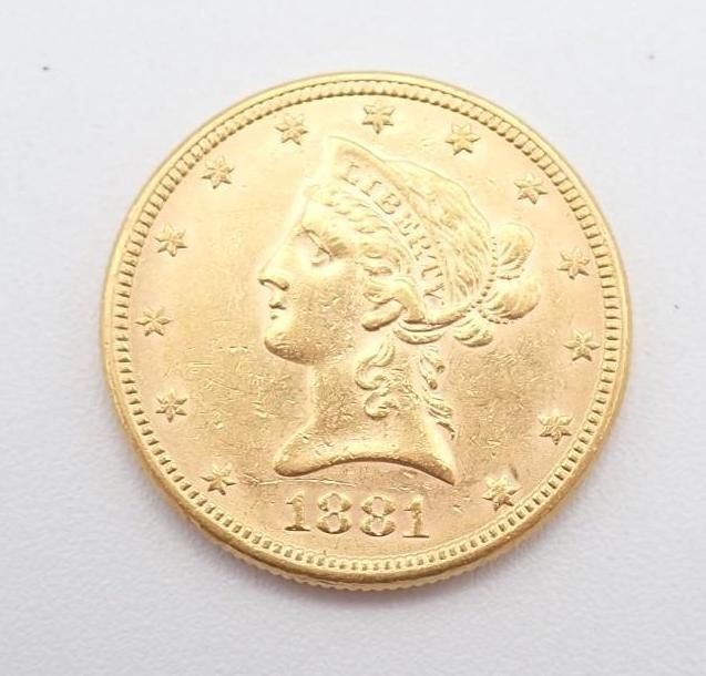 Gold coin with a left-facing profile and stars around the edge, dated 1881