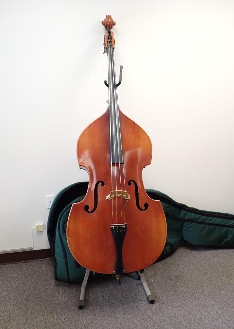 Upright brown double bass on a stand