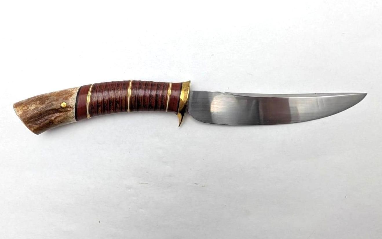 Hunting knife with a wrapped brown handle and curved silver blade on a white background