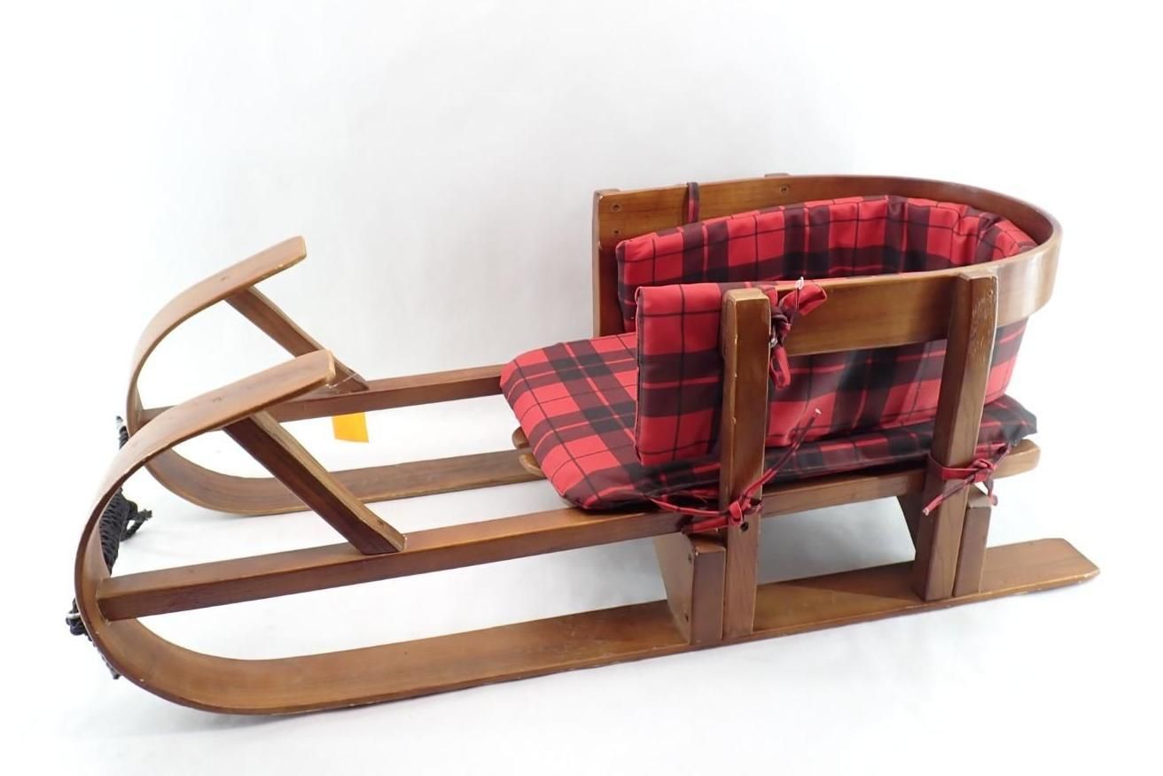 Vintage wooden sled with red plaid seat and backrest