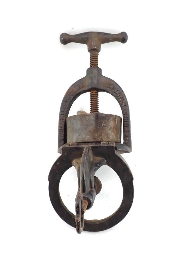 metal clamp with T-handle and circular ring on a white background
