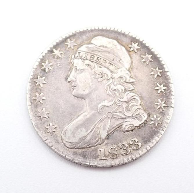 Silver coin with Lady Liberty profile and stars, dated 1833