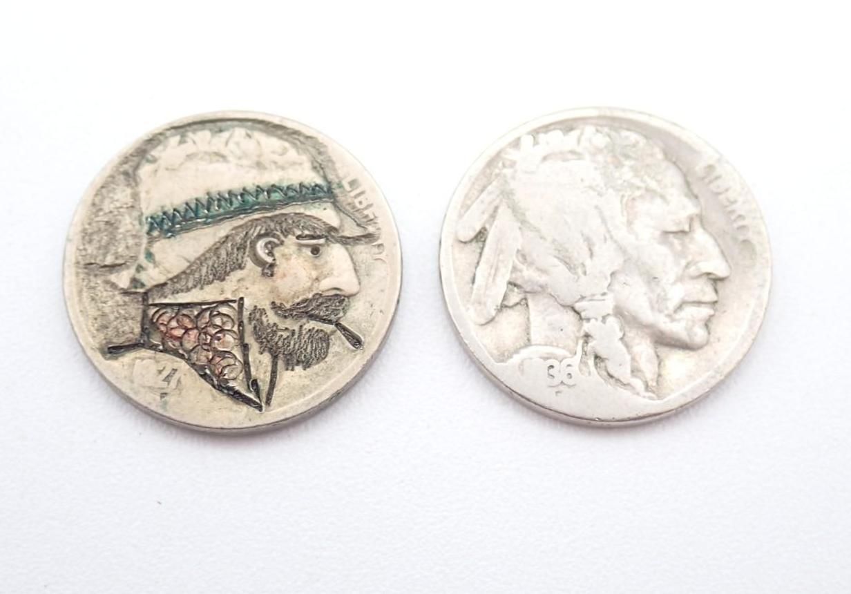 Two small silver coins with engraved profile heads on a white background