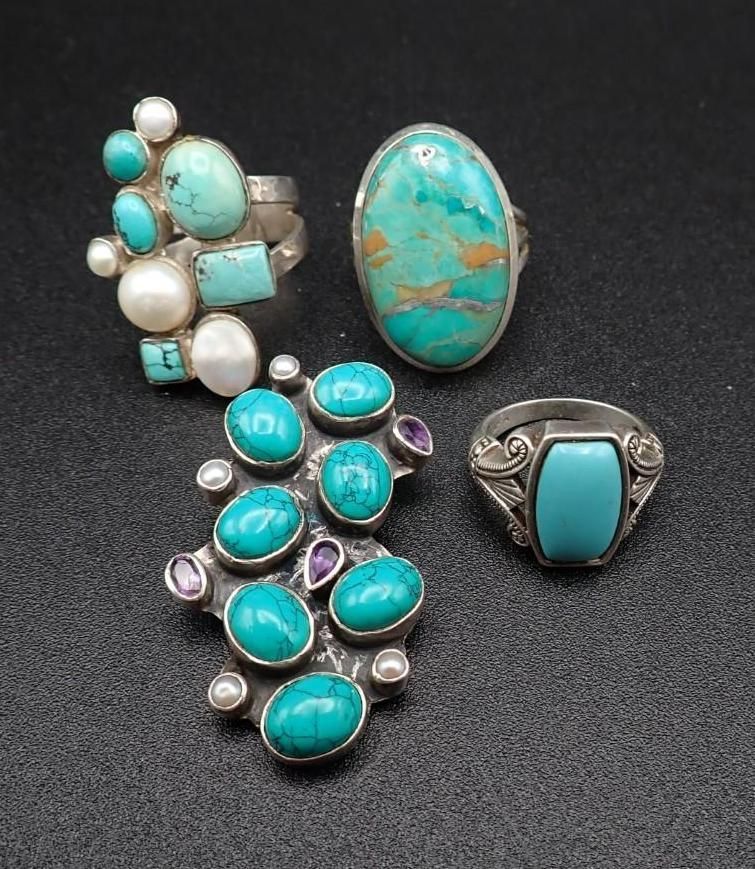 Turquoise and silver Native-style jewelry set with stone inlays and oval turquoise pendant on black background