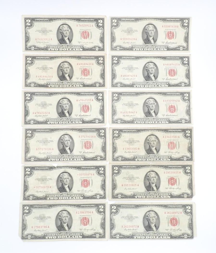 Eight two-dollar bills arranged in two columns on a light background.