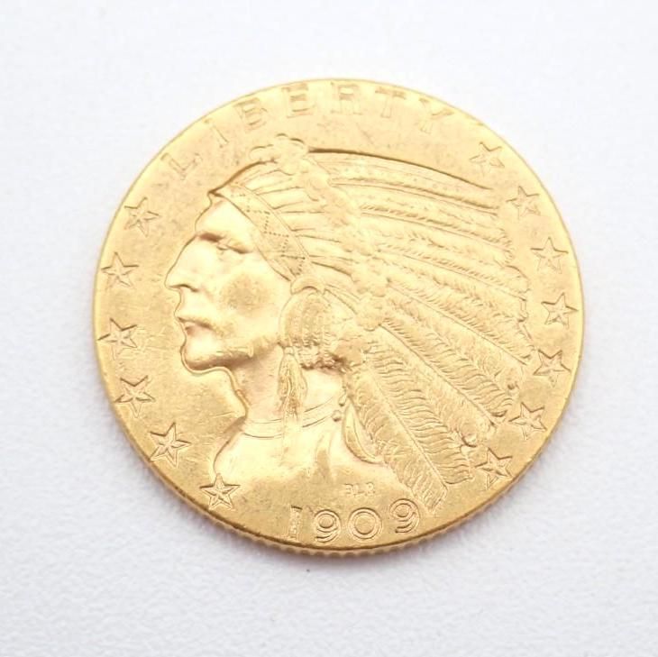 Gold coin with a Native American profile, stars around the edge, and the date 1902
