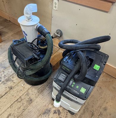 Two wet/dry vacuums and coiled hoses.
