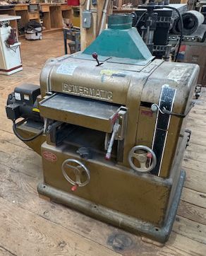 Vintage green metal industrial Powermatic machine.