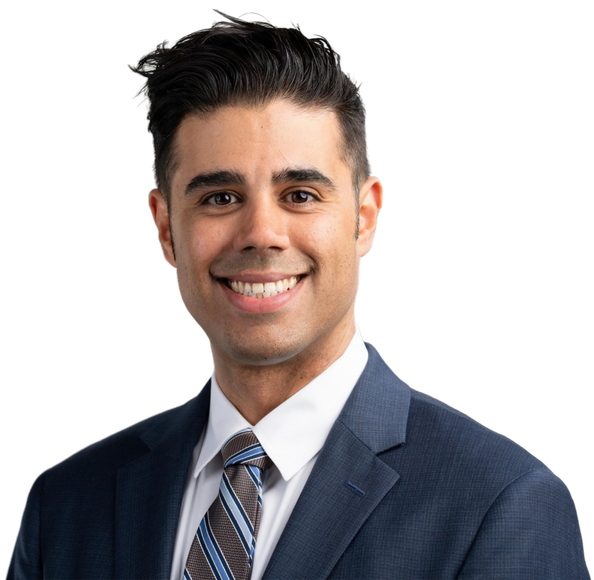 Portrait of a smiling man in a navy suit and striped tie on a white background