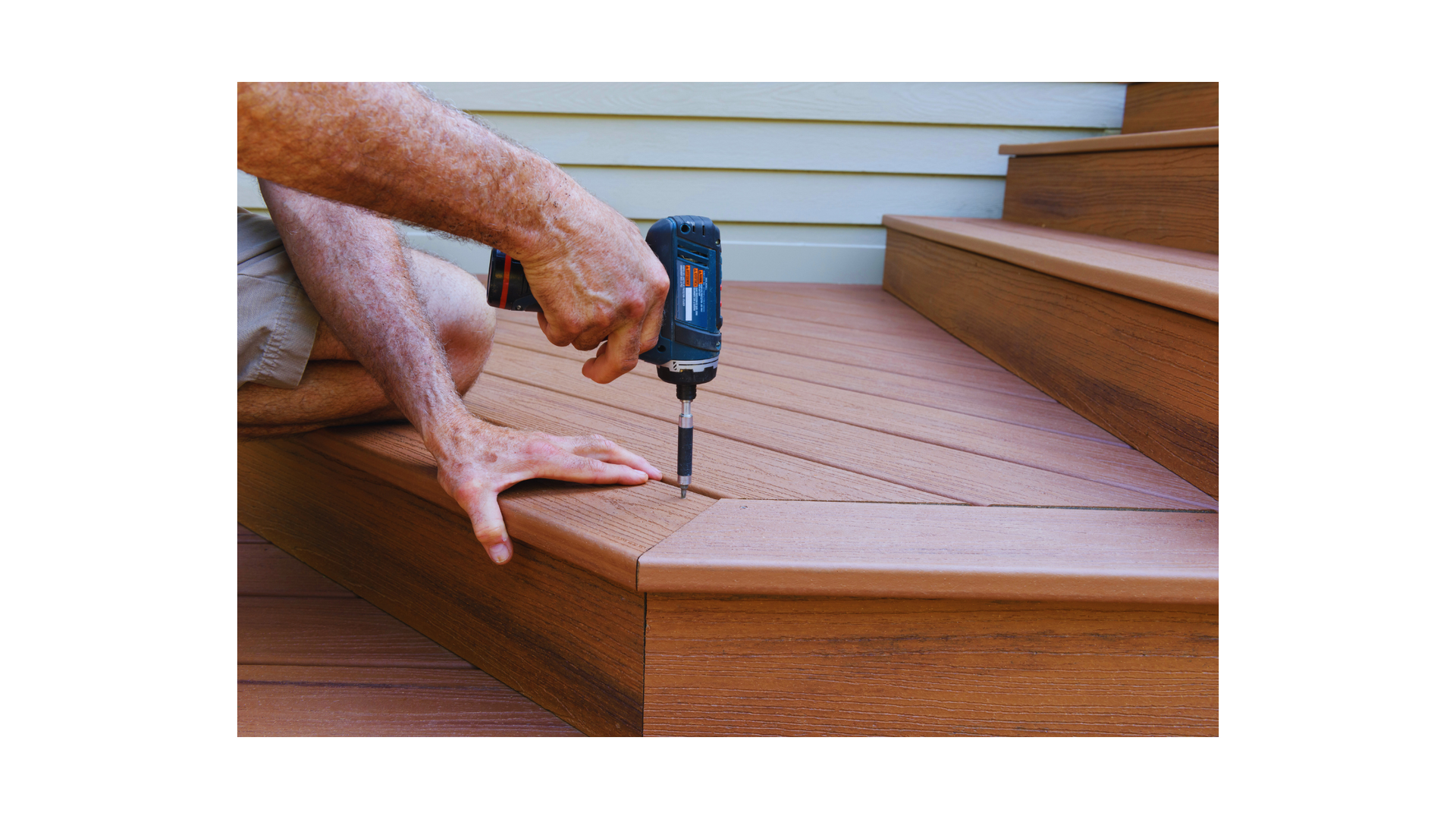 Craftsman aligning and securing
wooden deck boards, ensuring quality and durability in deck cons
