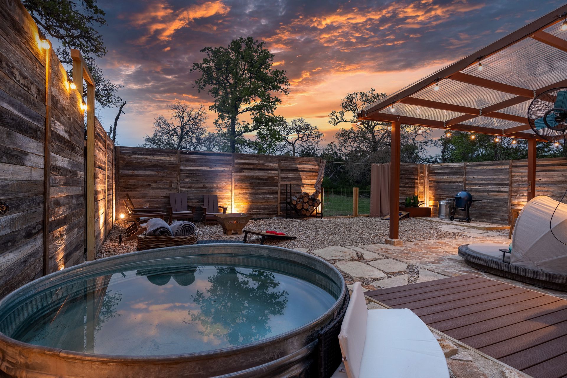 Quiroga private spa yard with plunge pool, sauna, fire pit, and pergola at sunset