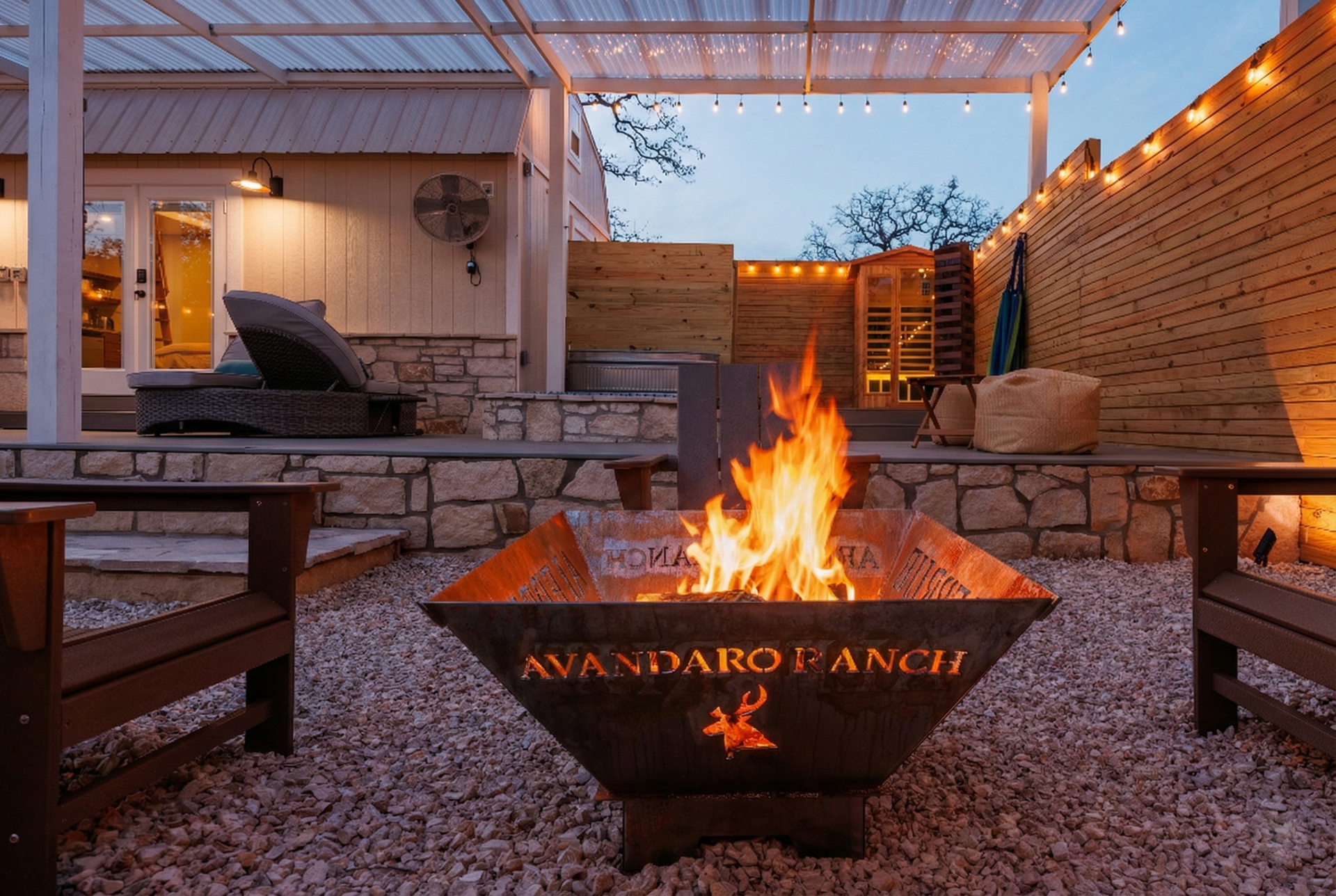 Alebrije private fire pit, sauna, and fenced spa yard at dusk
