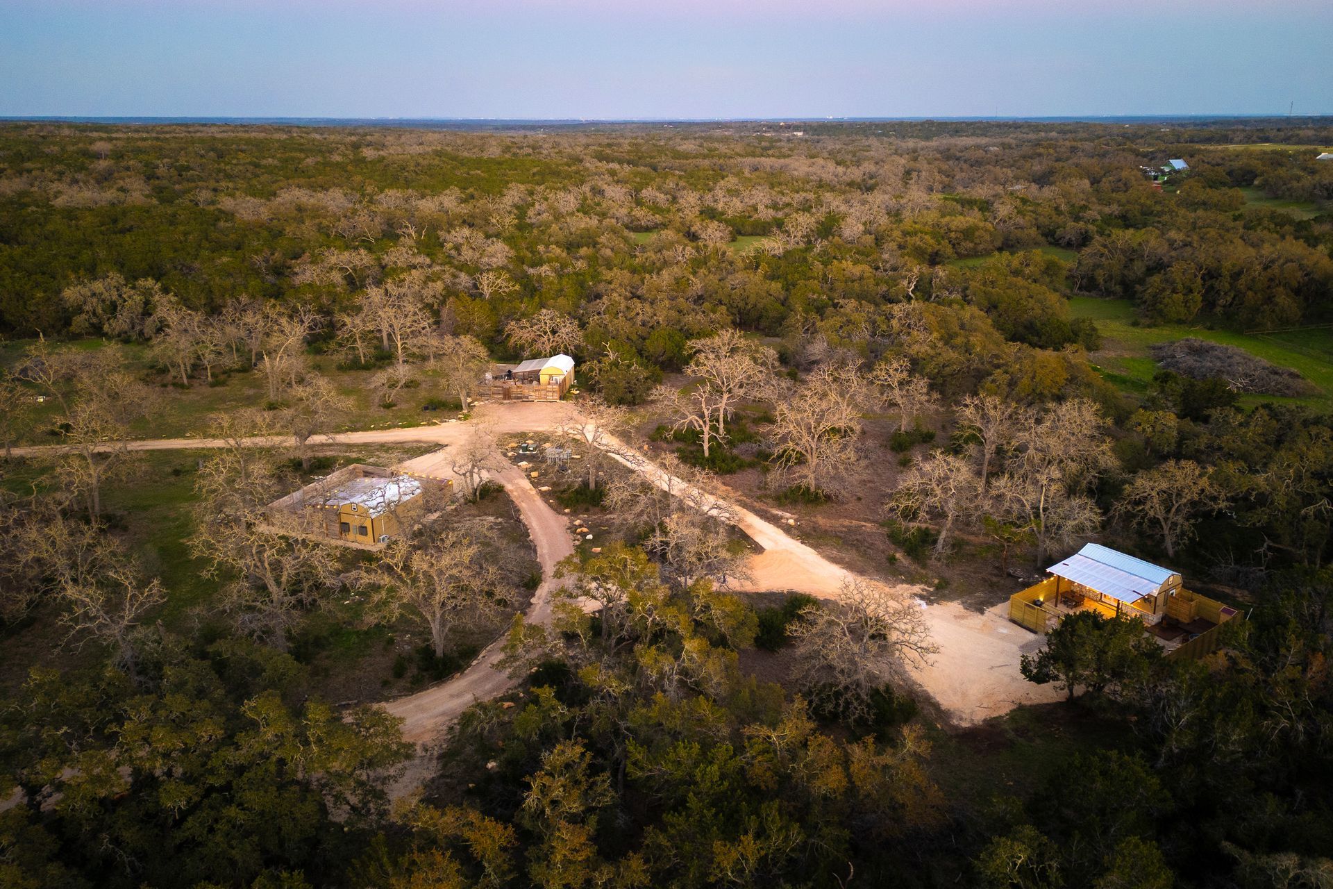 Aerial view of Avandaro Ranch cabins among Hill Country oaks