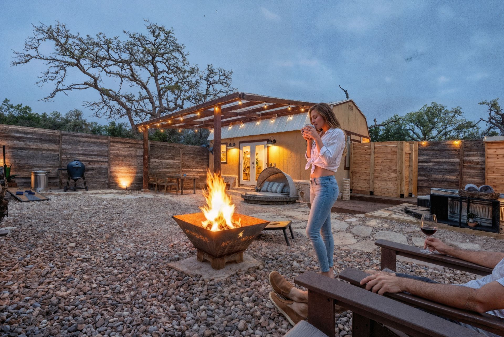 A couple by the private fire pit at dusk, inside their own fenced yard at Avandaro Ranch