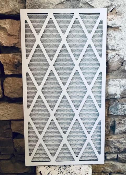 a man is working on an air conditioner outside of a brick building .