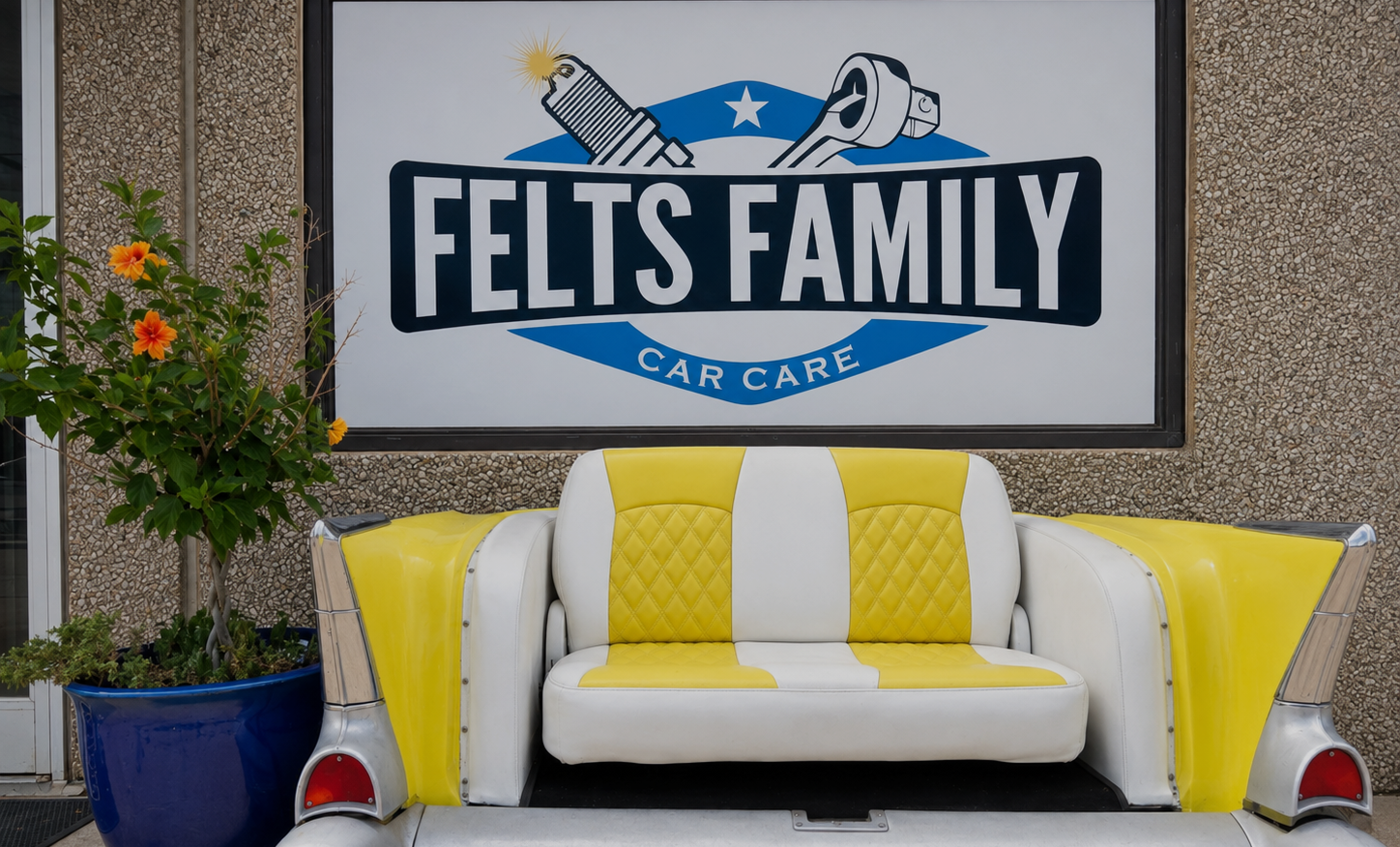 Felts Family Car Care sign above a yellow-and-white couch on a textured wall