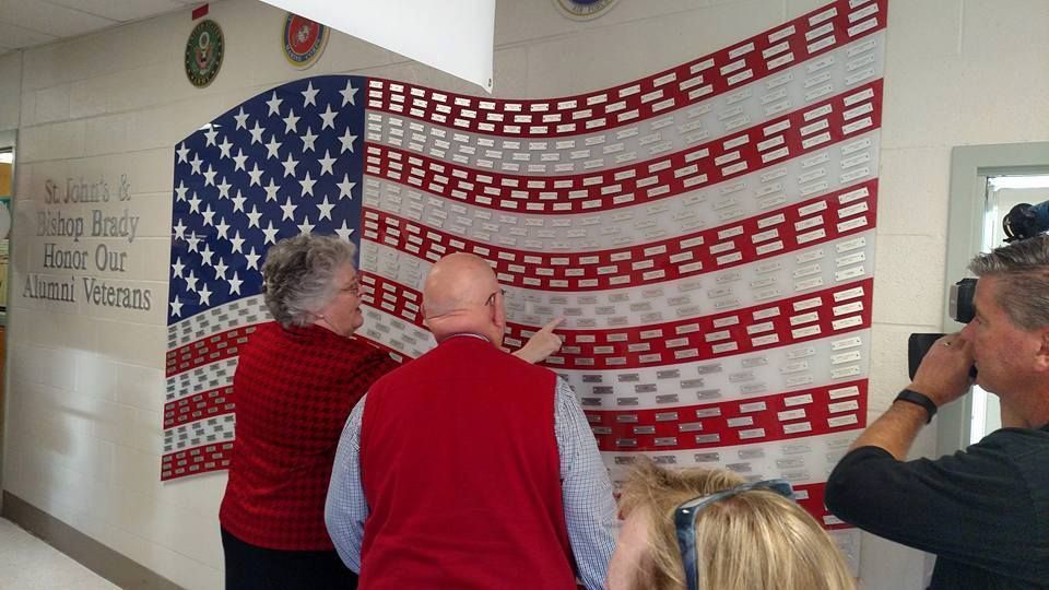 American flag with 2 people looking at it