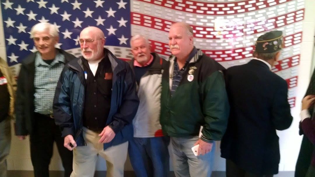 group of men in front of american flag