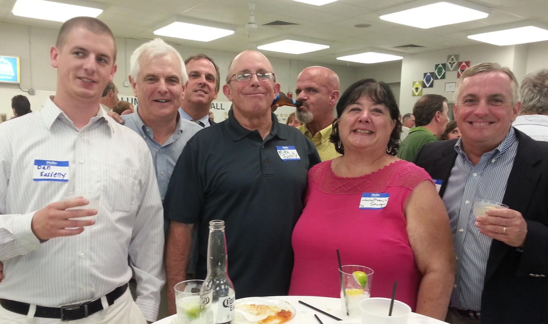 group of people smiling, table and food