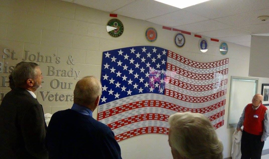 American flag with 2 people looking at it
