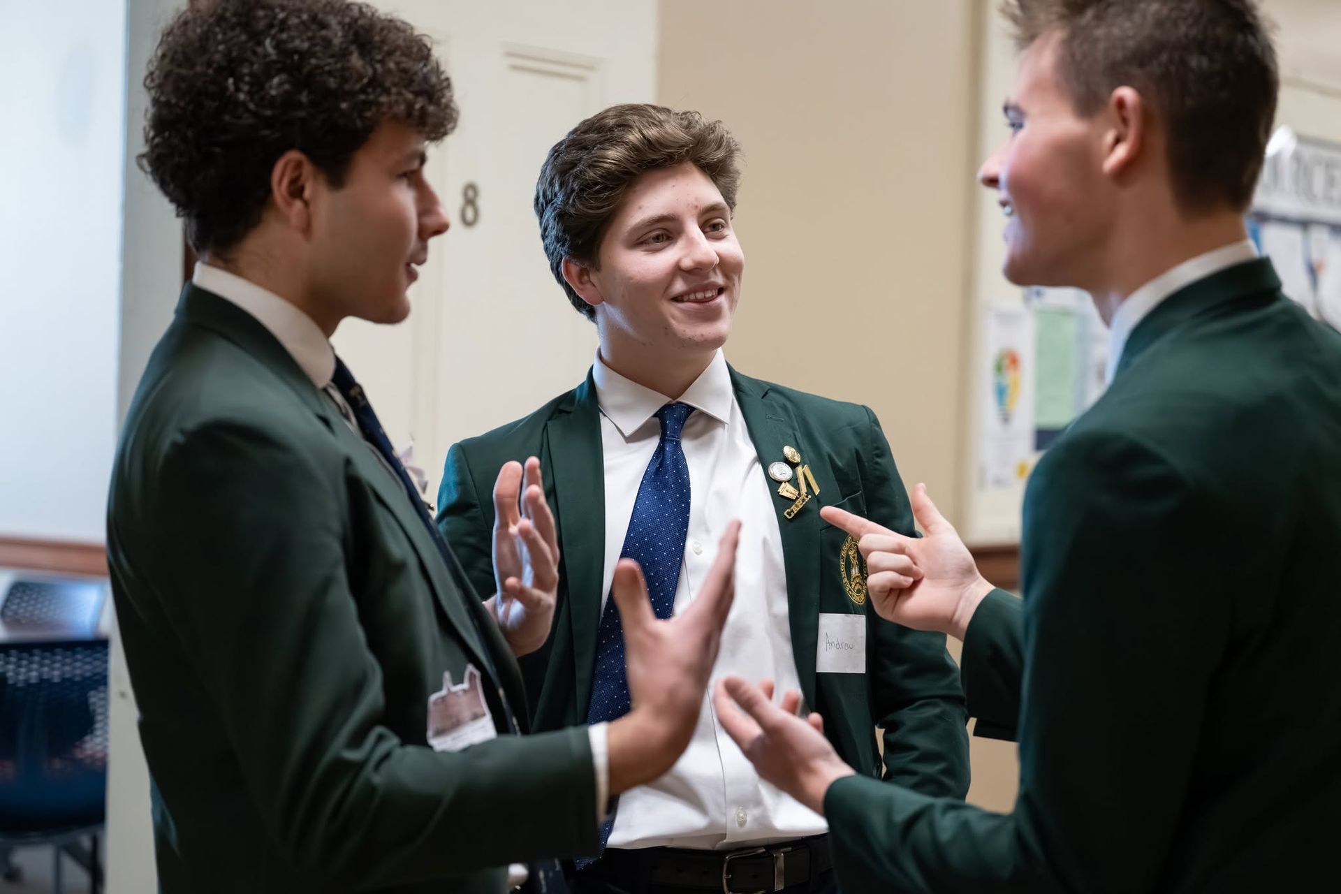3 students in conversation in classroom