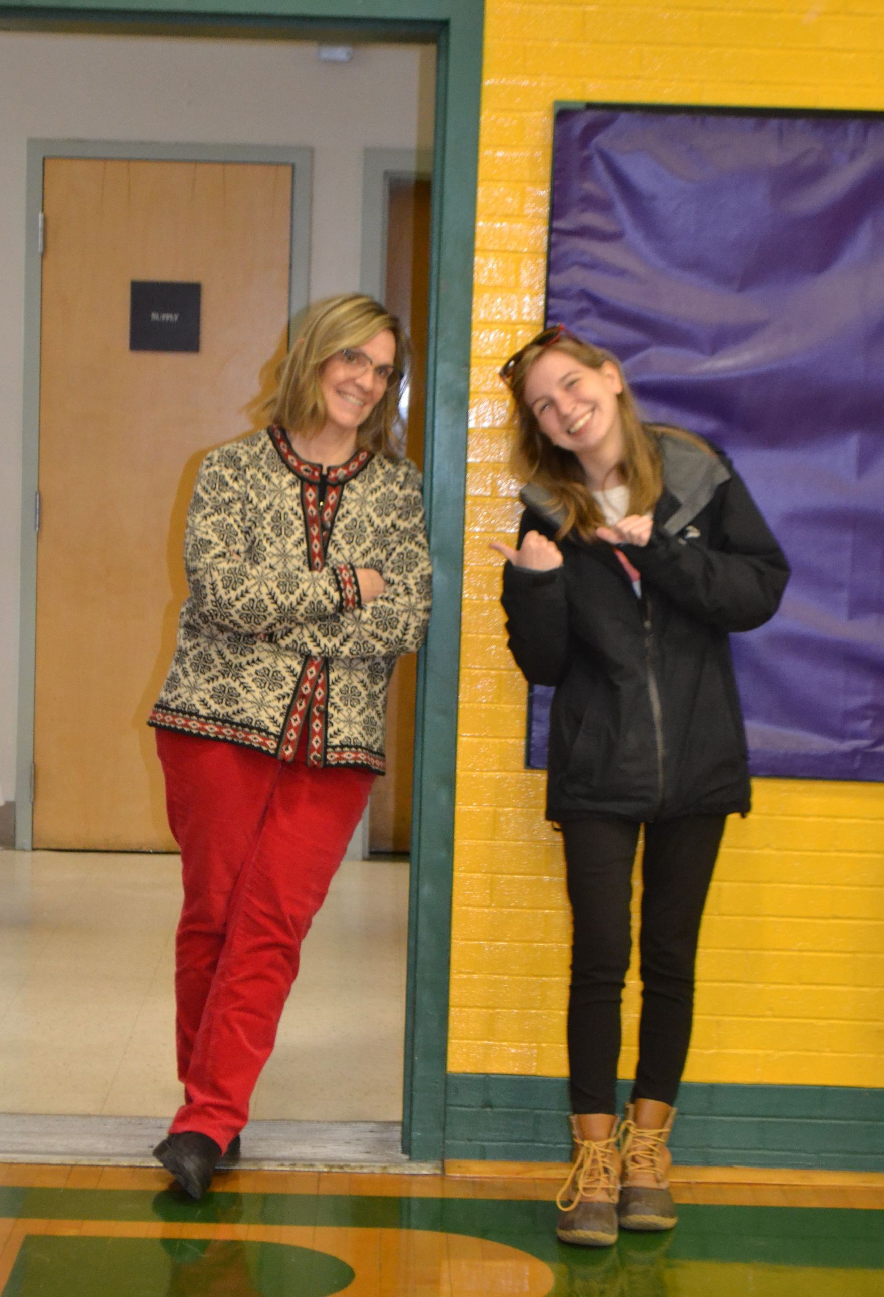 2 people smiling in a door way