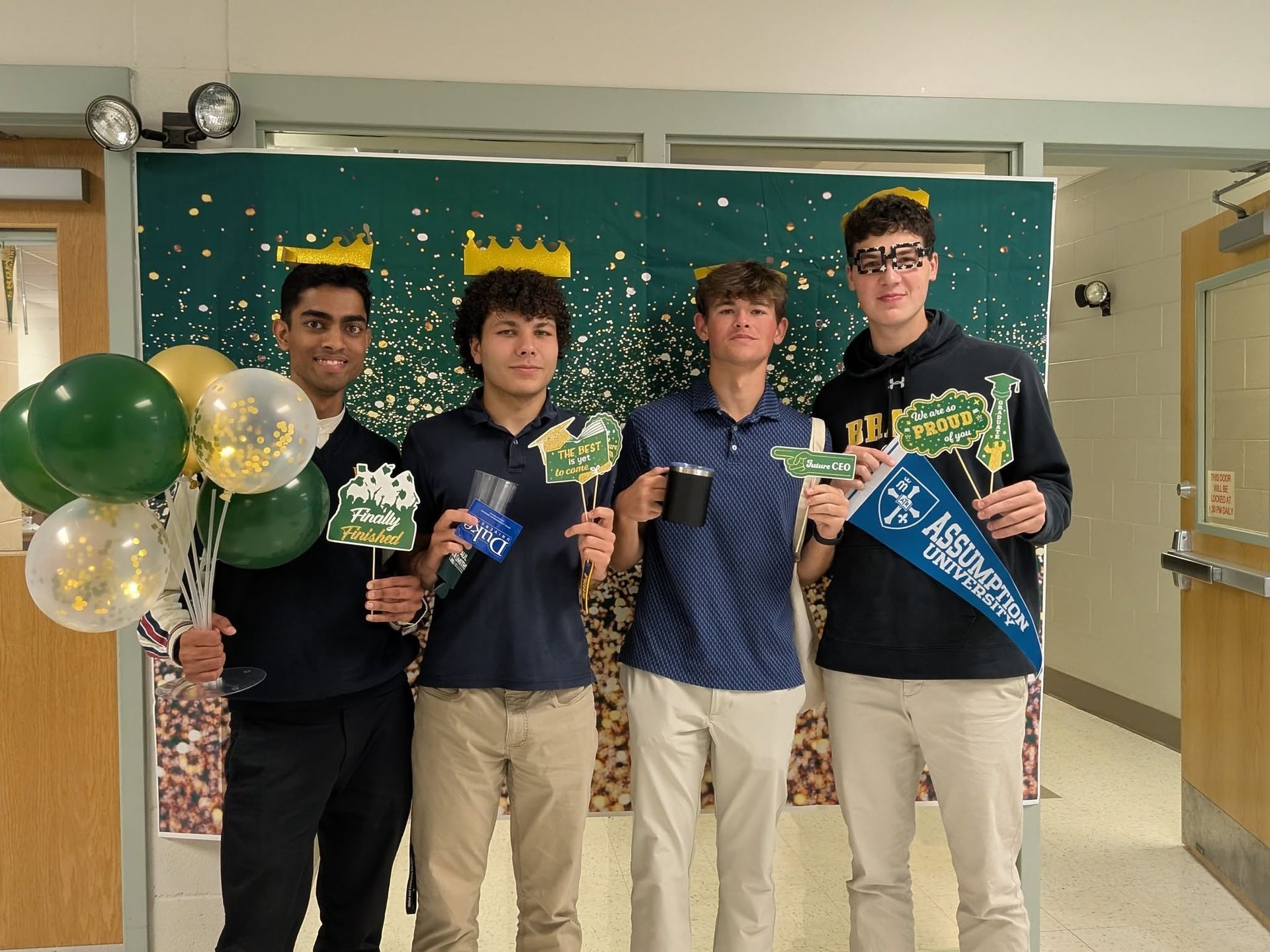 male students holding banners with college acceptances 