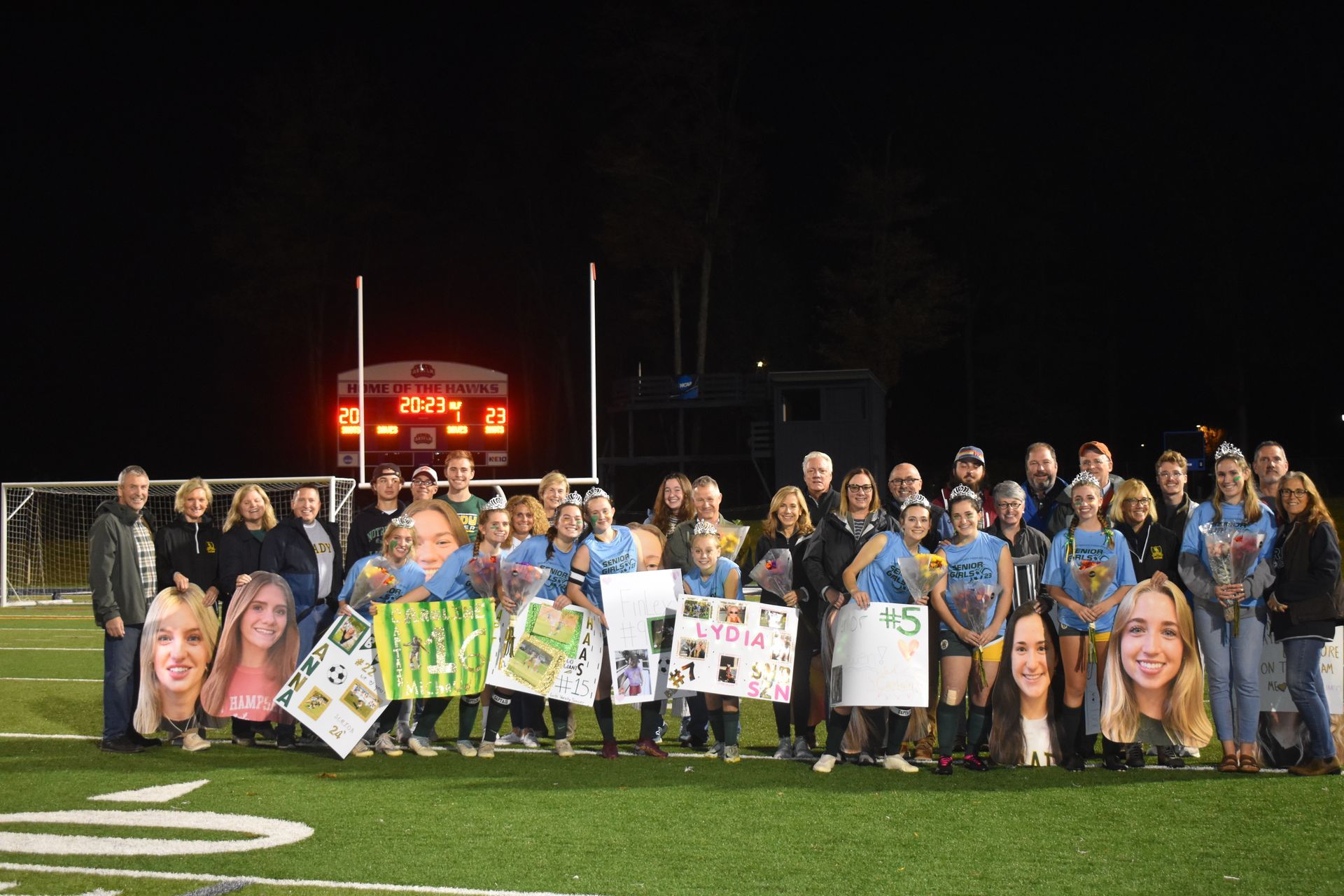 group of female athletes outside on a soccer field. 