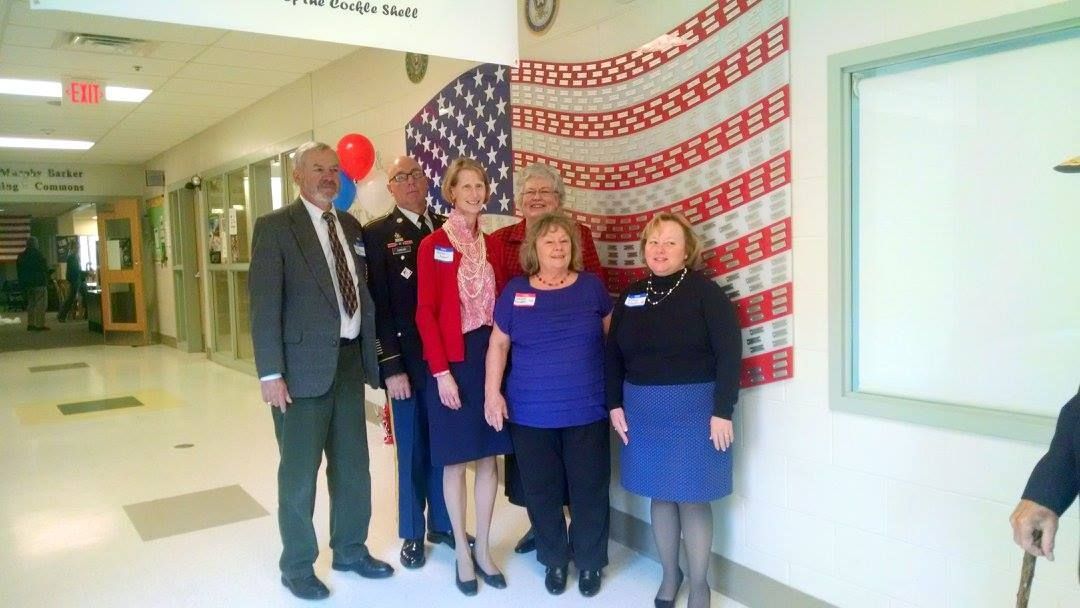 group of people flag in hallway of school