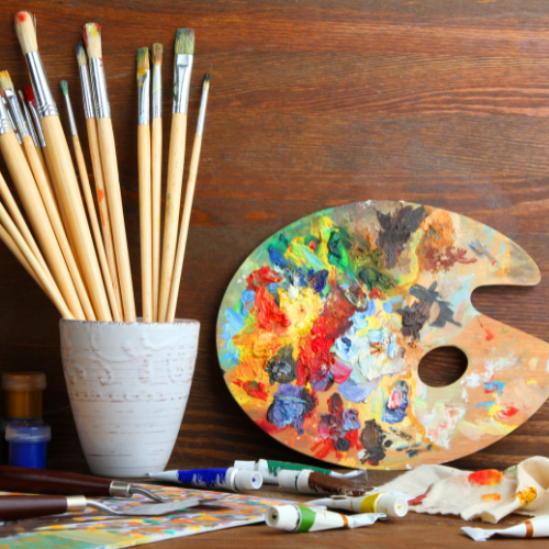 paint brushes, paints on a table