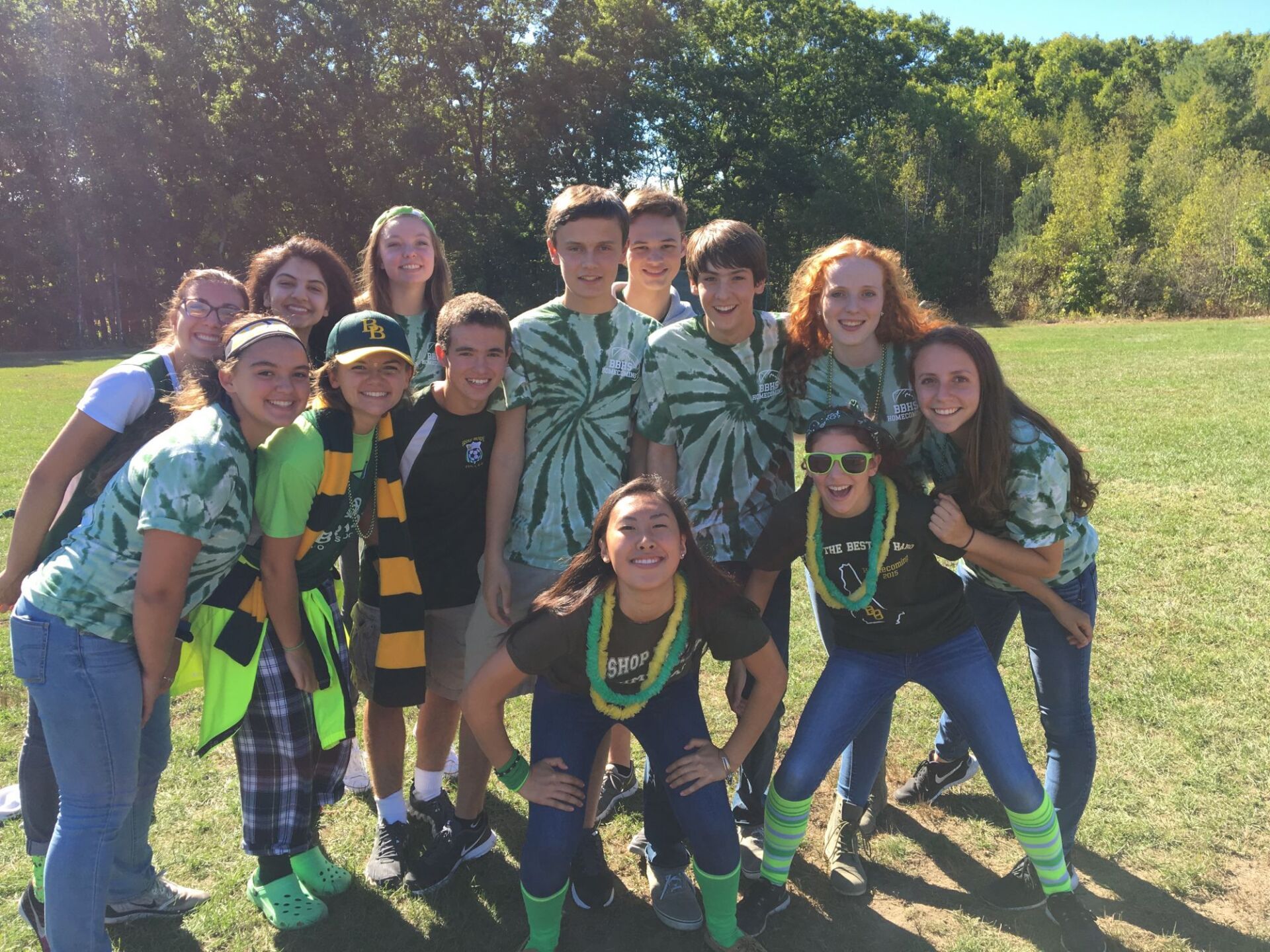 group of students outside, grass and trees