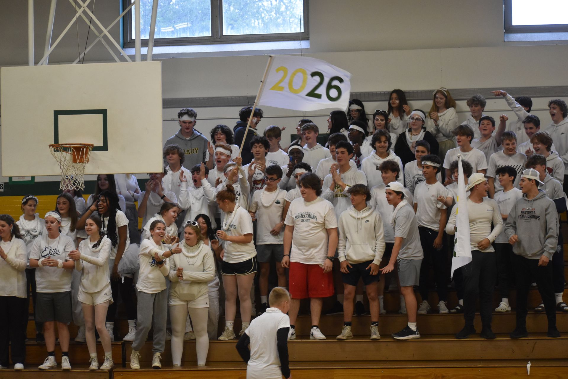 group of students wearing white on the gym  bleachers