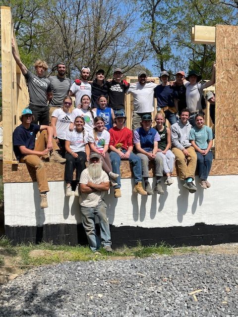 image of students smiling at a construction site