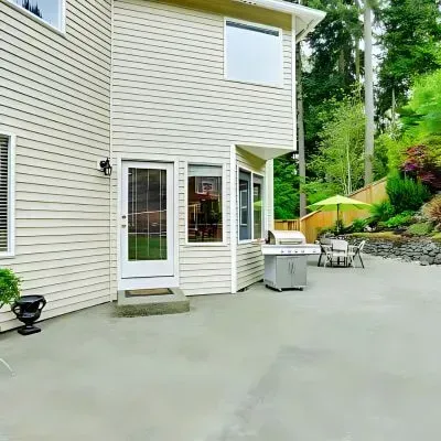 Stylish & Low-Maintenance: Modern Concrete Backyard Transforms a Pinehill Property.