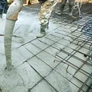 Concrete contractors are pumping onto a foundation, showcasing regulatory expertise in Dunedin.