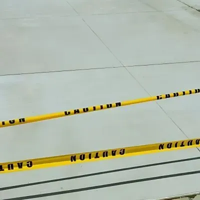 Newly poured concrete driveway in Corstophine, Dunedin, with tape waiting to cure.