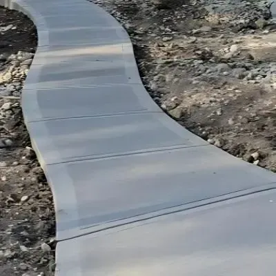 Sleek broom finish concrete path in Green Island.